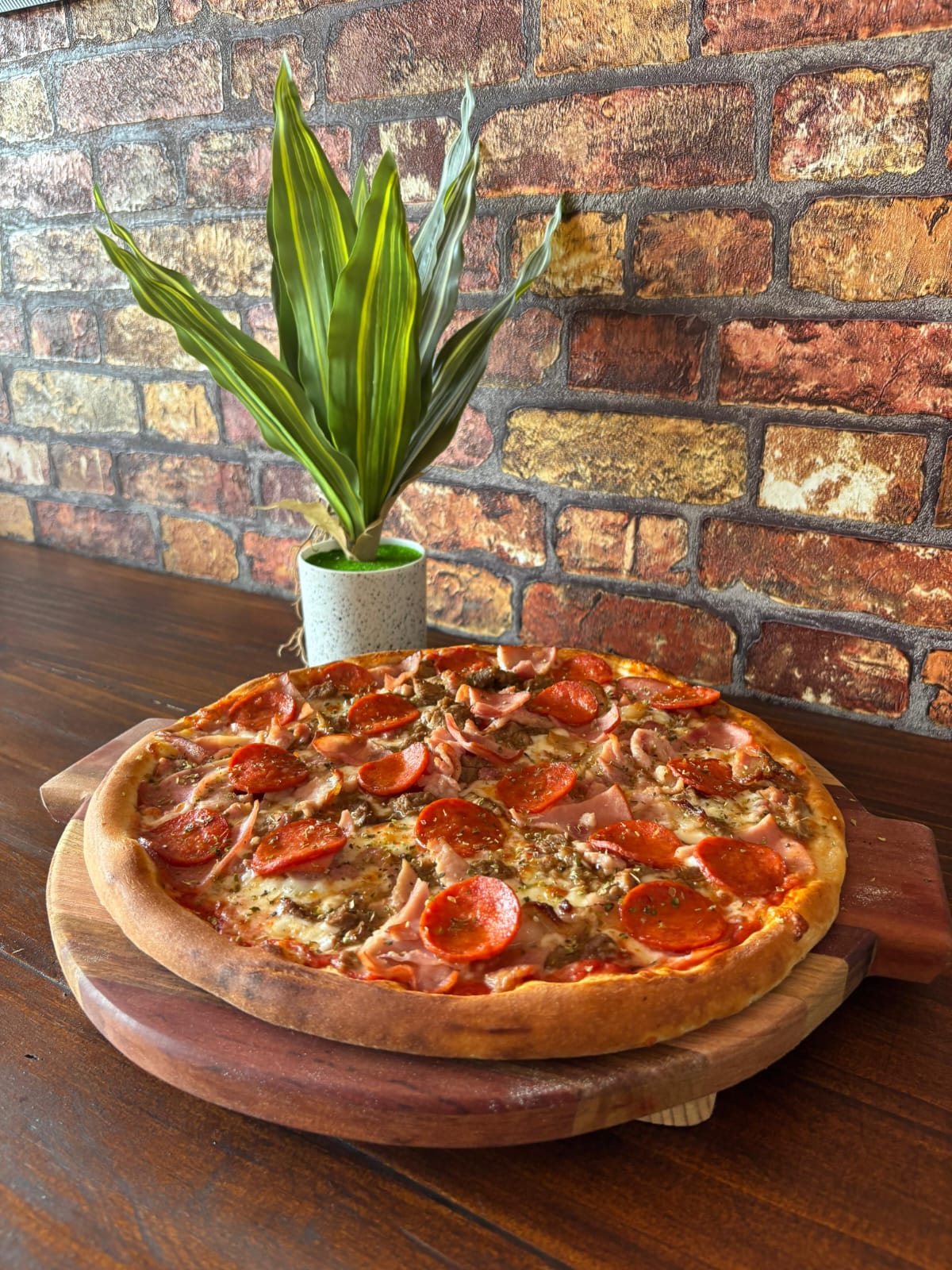 Freshly baked Lottie's pizza served on a wooden table