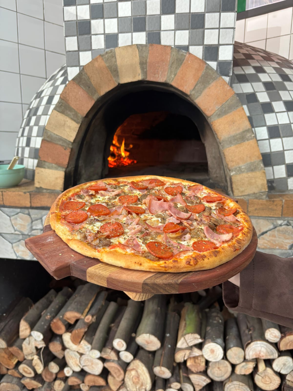 Fresh Lottie's pizza in front of the traditional wood-fired oven